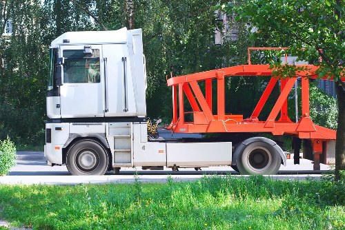 Electric waste collection van parked at a local transfer station